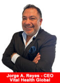 Jorge A. Reyes, CEO of Vital Health Global, smiling with arms crossed in a black blazer