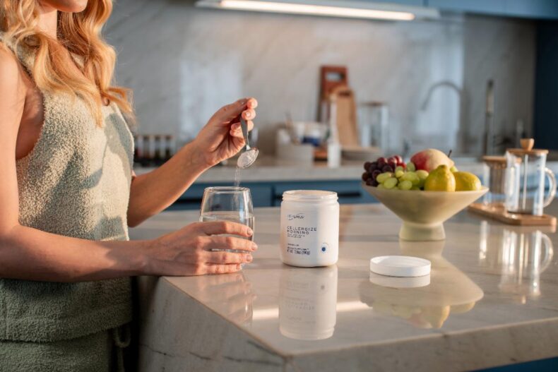 Woman preparing Cellergize Morning drink in her kitchen