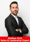 Professional portrait of Stefano Orrù, sales and leadership expert, standing with arms crossed